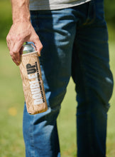 Load image into Gallery viewer, Hand holding a brown bag color double can cooler